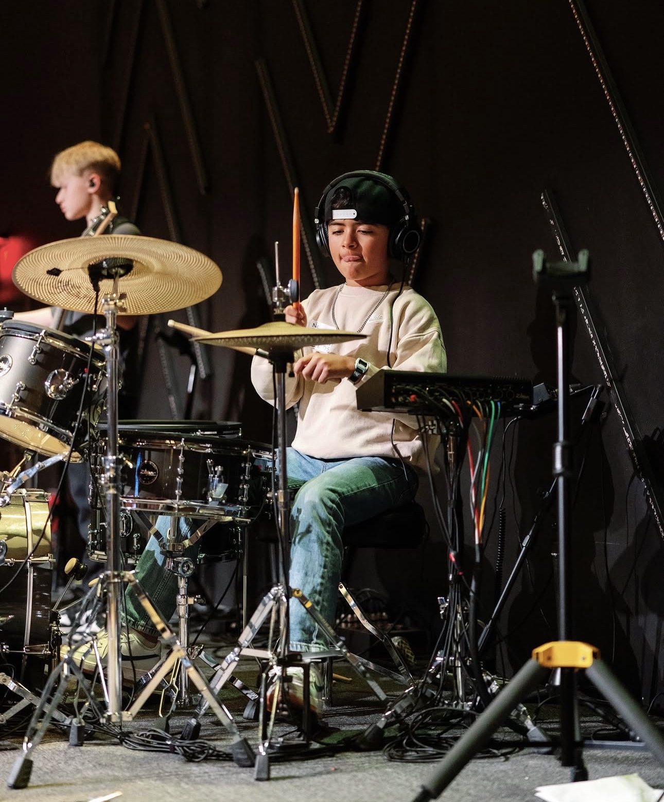 Student drummer rehearsing with headphones