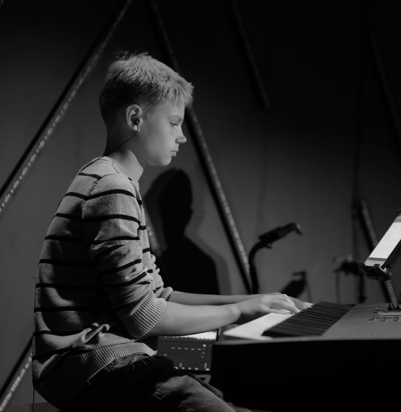 Student keyboard player focused during worship rehearsal