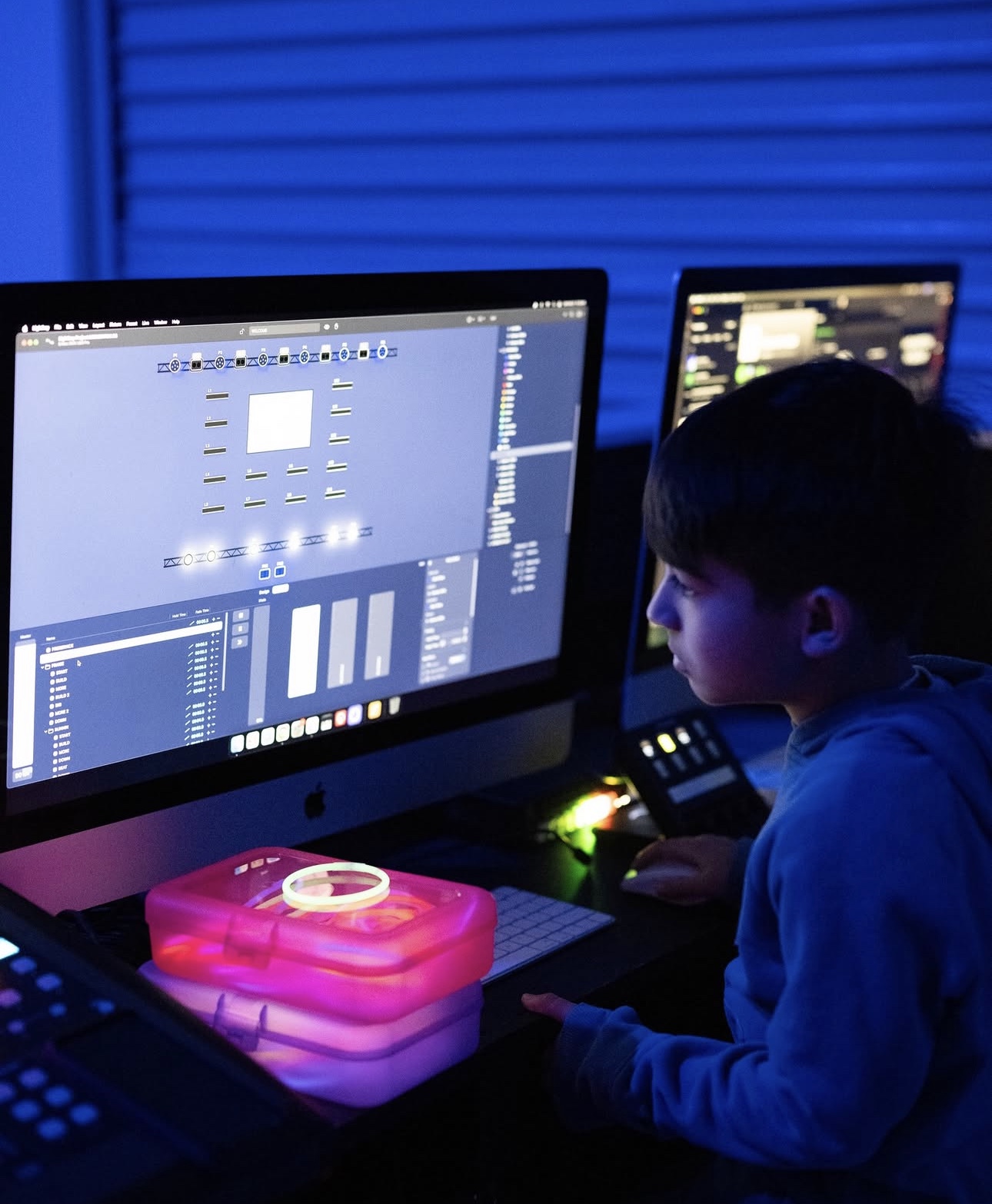 Student learning worship production at a lighting computer